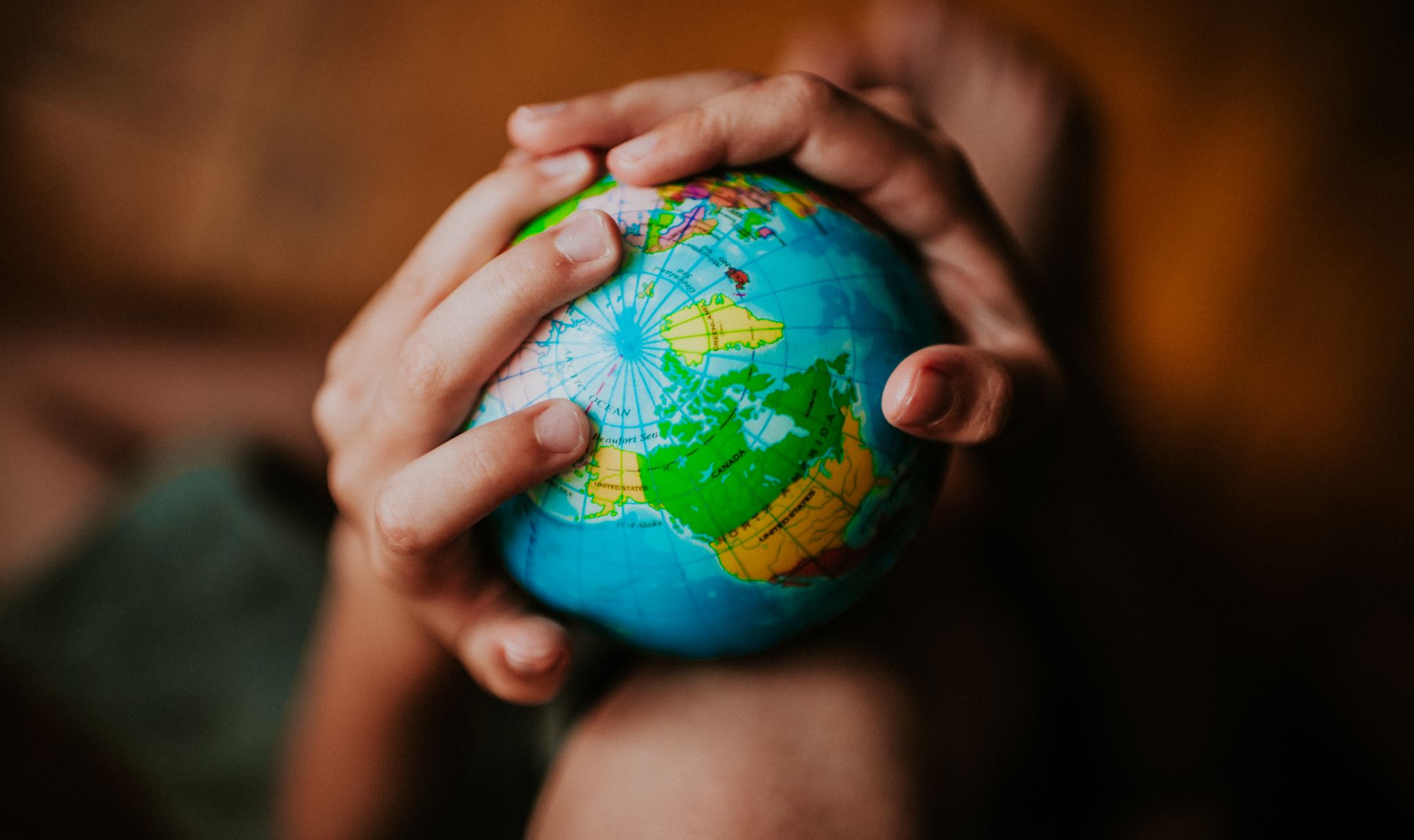 Hands holding a globe
